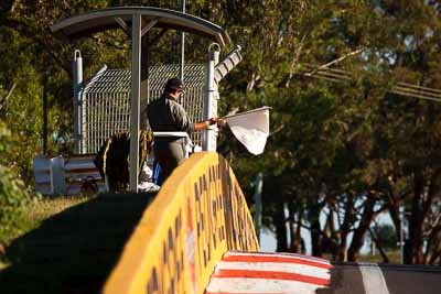 5-April-2010;Australia;Bathurst;FOSC;Festival-of-Sporting-Cars;Mt-Panorama;NSW;New-South-Wales;atmosphere;auto;flag-marshal;motorsport;racing;super-telephoto